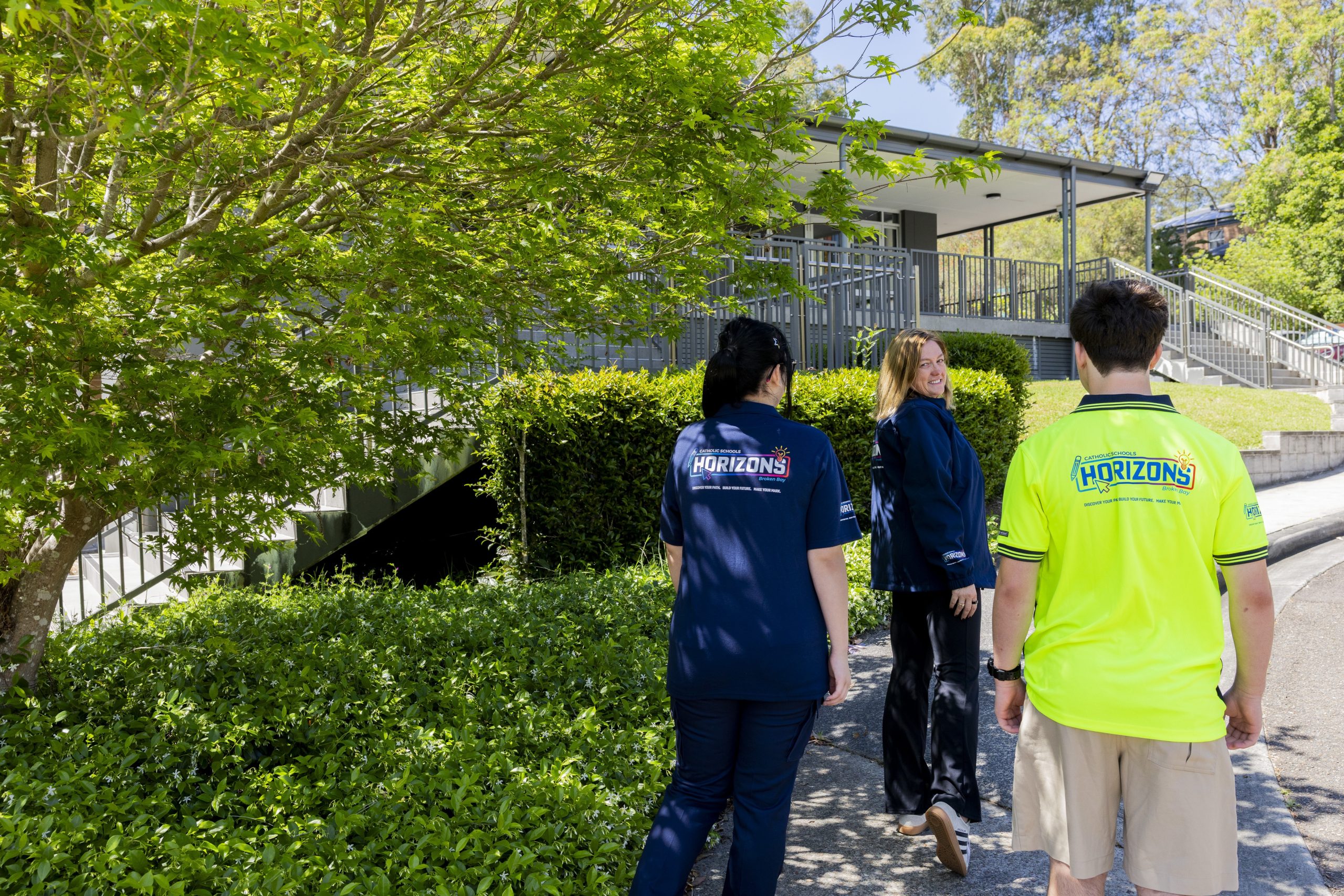 People wearing Horizons uniforms walking together outdoors.