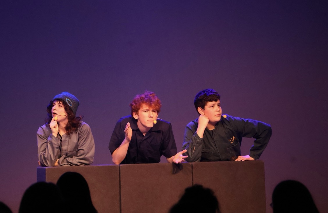 Performers bringing a scene to life on stage